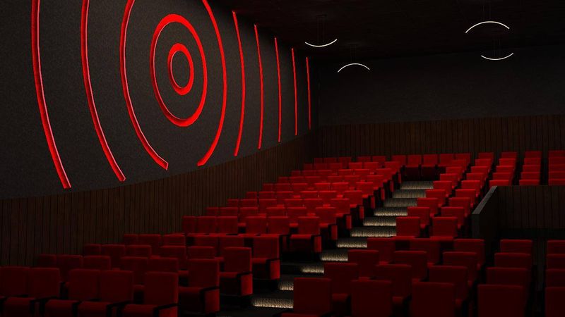3D render of a theatre auditorium with red seating